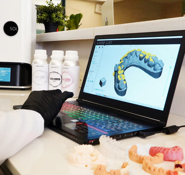 Alpha 3D slicing software with a model, with Curo resins and Ackuretta SOL in the background